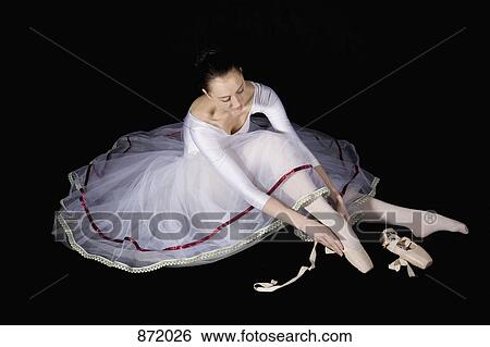 A ballet dancer putting on her pointe shoe View Large Photo Image Stock Photograph - A ballet dancer putting on her pointe shoe. Fotosearch