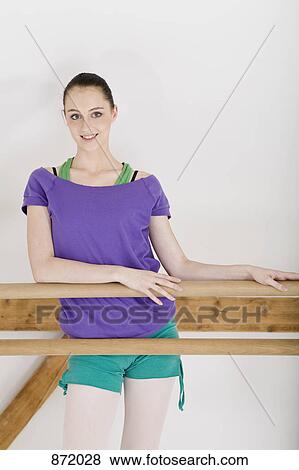 A ballet dancer resting at the barre in a ballet studio View Large Photo Image Stock Photo - A ballet dancer resting at the barre in a ballet studio. Fotosearch
