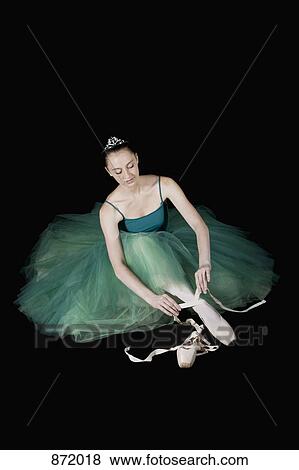 A ballet dancer wearing a costume tying her pointe shoe View Large Photo Image Stock Photo - A ballet dancer wearing a costume tying her pointe shoe. Fotosearch