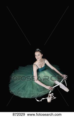 A ballet dancer wearing a costume tying her pointe shoe View Large Photo Image Stock Photo - A ballet dancer wearing a costume tying her pointe shoe. Fotosearch