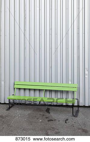 A green bench in front of a steel building View Large Photo Image Stock Photography - A green bench in front of a steel building. Fotosearch