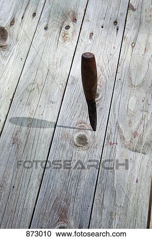 A knife stuck in a wooden plank View Large Photo Image Stock Image - A knife stuck in a wooden plank. Fotosearch