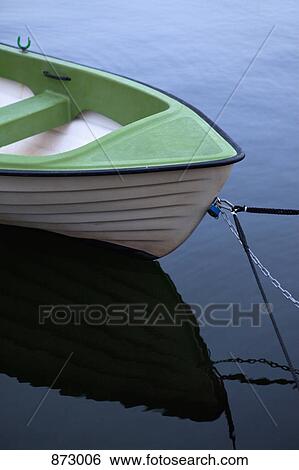 A small rowing boat moored on water View Large Photo Image Stock Photograph - A small rowing boat moored on water. Fotosearch