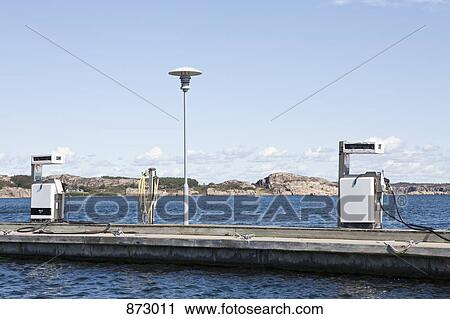 Stock Image - Petrol pumps on a pier. Fotosearch
