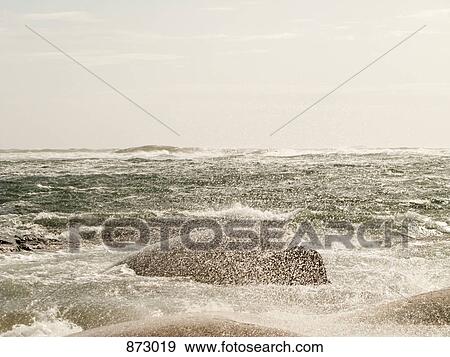 Stock Photo - Waves crashing over rocks. Fotosearch