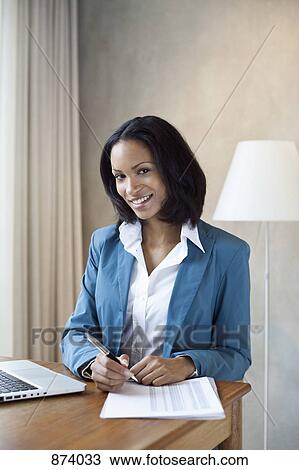 A businesswoman preparing to sign a document View Large Photo Image Stock Image - A businesswoman preparing to sign a document. Fotosearch