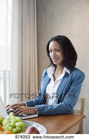 A businesswoman working at a desk View Large Photo Image Stock Image - A businesswoman working at a desk. Fotosearch