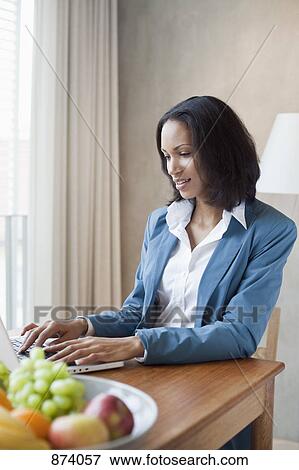 A businesswoman working at a desk View Large Photo Image Stock Photo - A businesswoman working at a desk. Fotosearch
