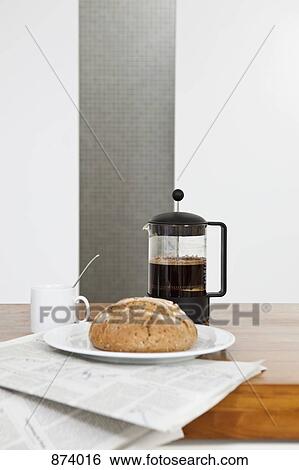A French press, bread, coffee cup and newspaper View Large Photo Image Stock Photograph - A French press, bread, coffee cup and newspaper. Fotosearch