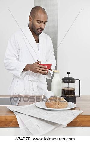 A man in a bathrobe having breakfast View Large Photo Image Stock Image - A man in a bathrobe having breakfast. Fotosearch