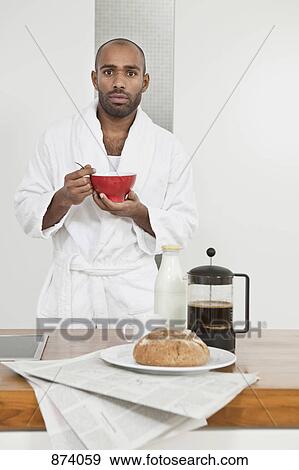A man in a bathrobe having breakfast View Large Photo Image Stock Photo - A man in a bathrobe having breakfast. Fotosearch