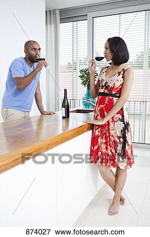 A young couple drinking red wine View Large Photo Image Stock Photo - A young couple drinking red wine. Fotosearch