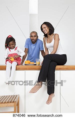 Stock Photograph - A young family relaxing. Fotosearch