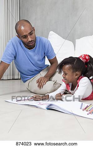 A young girl coloring with her father View Large Photo Image Stock Image - A young girl coloring with her father. Fotosearch