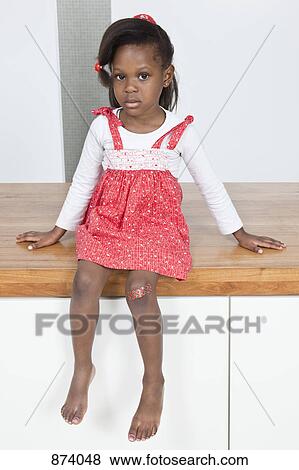 Stock Photo - A young girl with a bandaged knee. Fotosearch