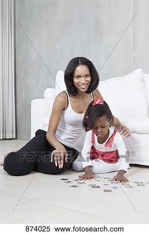 A young mother and her daughter playing a card game View Large Photo Image Stock Photography - A young mother and her daughter playing a card game. Fotosearch