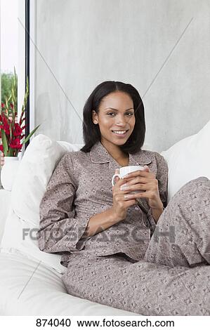 A young woman relaxing in the morning View Large Photo Image Stock Image - A young woman relaxing in the morning. Fotosearch