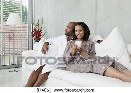 Portrait of a young couple on a sofa View Large Photo Image Stock Image - Portrait of a young couple on a sofa. Fotosearch