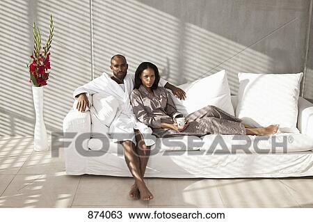 Portrait of a young couple on a sofa View Large Photo Image Stock Image - Portrait of a young couple on a sofa. Fotosearch