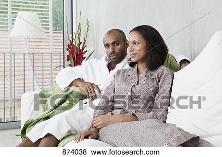 Portrait of a young couple on a sofa View Large Photo Image Stock Photo - Portrait of a young couple on a sofa. Fotosearch