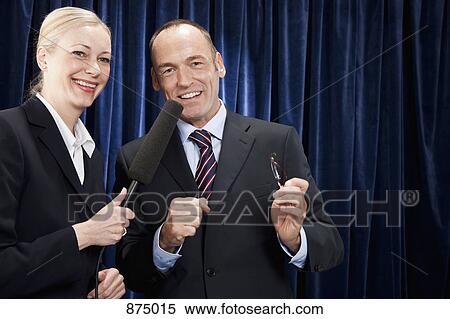 Stock Photography - A man in a suit being interviewed by a woman. Fotosearch