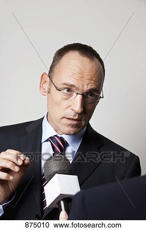 A man in a suit being interviewed View Large Photo Image Stock Image - A man in a suit being interviewed. Fotosearch