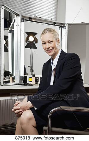A woman in a suit sitting backstage View Large Photo Image Stock Photo - A woman in a suit sitting backstage. Fotosearch