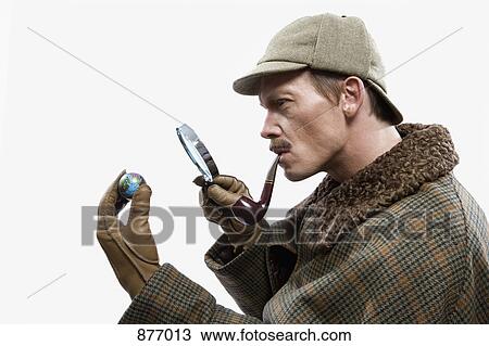 A man dressed up as Sherlock Holmes looking at a tiny globe through a magnifying glass View Large Photo Image Stock Image - A man dressed up as Sherlock Holmes looking at a tiny globe through a magnifying glass. Fotosearch