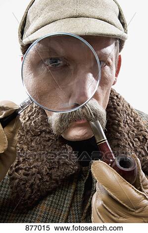 A man dressed up as Sherlock Holmes with a magnifying glass distorting his eye View Large Photo Image Stock Photography - A man dressed up as Sherlock Holmes with a magnifying glass distorting his eye. Fotosearch