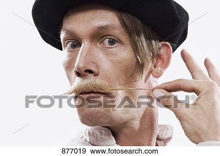 A man twisting his mustache View Large Photo Image Stock Photo - A man twisting his mustache. Fotosearch