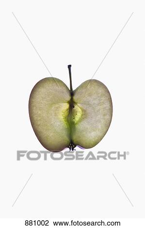 Stock Image - A slice of an organic apple on a lightbox. Fotosearch