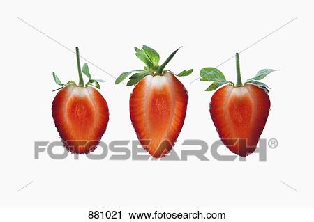 Stock Image - Three slices of an organic strawberry on a lightbox. Fotosearch