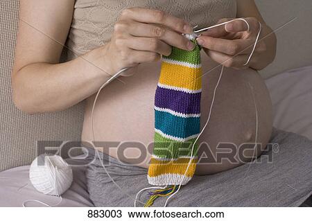 A pregnant woman knitting, midsection View Large Photo Image Stock Image - A pregnant woman knitting, midsection. Fotosearch