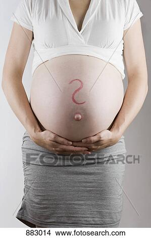 A question mark drawn on a pregnant belly, midsection, focus on abdomen View Large Photo Image Picture - A question mark drawn on a pregnant belly, midsection, focus on abdomen. Fotosearch