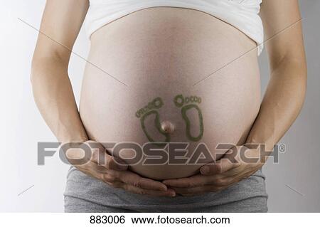 Baby footprints drawn on a pregnant belly, midsection, focus on abdomen View Large Photo Image Stock Photograph - Baby footprints drawn on a pregnant belly, midsection, focus on abdomen. Fotosearch