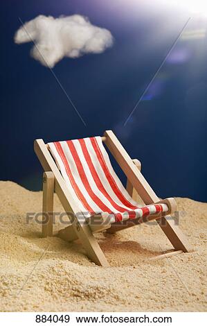 A miniature beach chair in sand View Large Photo Image Stock Photo - A miniature beach chair in sand. Fotosearch