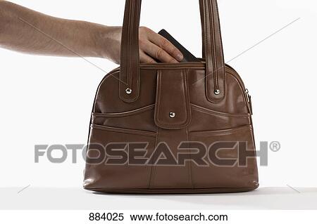 Detail of a man reaching into a handbag View Large Photo Image Stock Photography - Detail of a man reaching into a handbag. Fotosearch