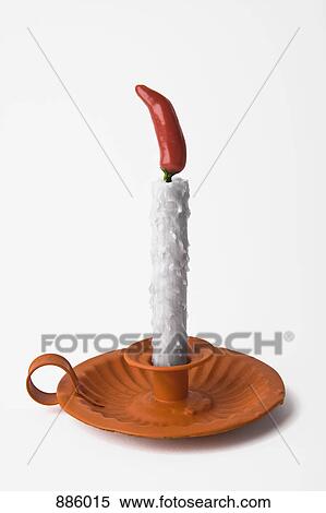 A candle with a chili as the flame View Large Photo Image Stock Photography - A candle with a chili as the flame. Fotosearch