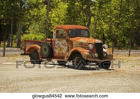 Stock Image - Abandoned pick-up truck parked on a field. Fotosearch