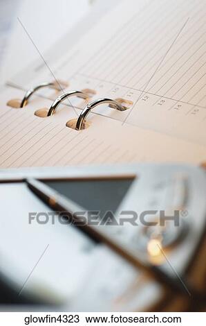 Stock Image - Appointment book, PDA and pen, close-up. Fotosearch