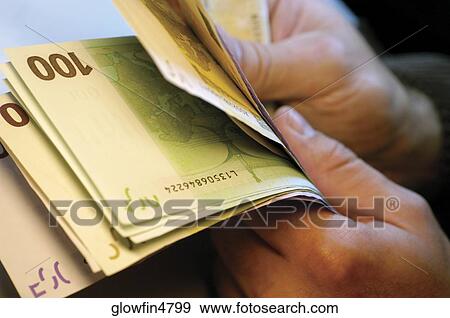 Businessman holding several one hundred Euro bank notes, close-up View Large Photo Image Stock Photo - Businessman holding several one hundred Euro bank notes, close-up. Fotosearch