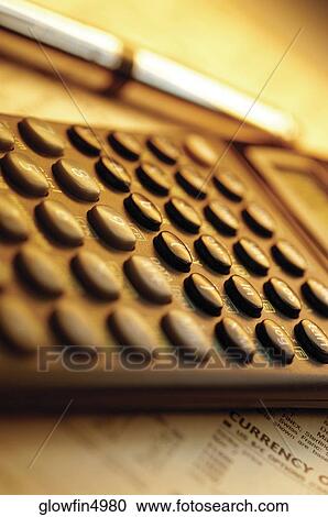 Calculator and pen on top of list of financial data, close-up View Large Photo Image Stock Image - Calculator and pen on top of list of financial data, close-up. Fotosearch