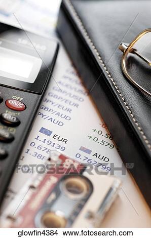 Picture - Calculator, stock market list, glasses, leather glasses case and micro cassette tape, close-up. Fotosearch