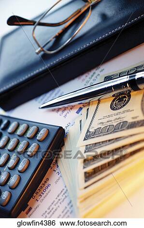Calculator, stock market list, glasses, leather glasses case, pen and United States one hundred dollar bills, close-up View Large Photo Image Stock Photograph - Calculator, stock market list, glasses, leather glasses case, pen and United States one hundred dollar bills, close-up. Fotosearch