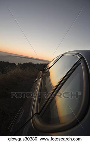 Car parked on a hill at dusk View Large Photo Image Stock Image - Car parked on a hill at dusk. Fotosearch