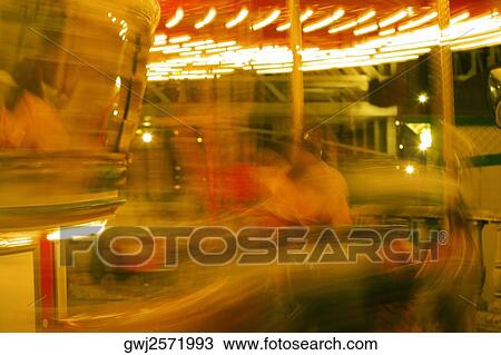 Stock Image - Carousel in an amusement park at night, San Diego, California, USA. Fotosearch