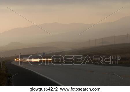 Cars on a stretch of road at dusk View Large Photo Image Stock Image - Cars on a stretch of road at dusk. Fotosearch