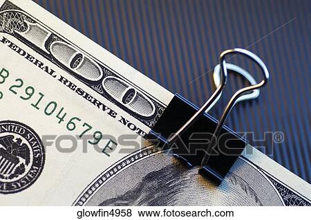 Clip on top of United States one hundred dollar bill, close-up View Large Photo Image Stock Photo - Clip on top of United States one hundred dollar bill, close-up. Fotosearch
