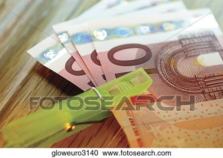 Close-up of a clothes peg on a stack of ten Euro banknotes View Large Photo Image Stock Image - Close-up of a clothes peg on a stack of ten Euro banknotes. Fotosearch
