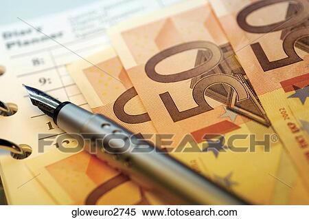Stock Photography - Close-up of a pen on fifty Euro banknotes. Fotosearch